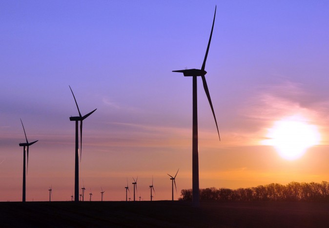 Turbines spin as the sun rises at a wind farm near Toronto, S.D., in 2011. (AP Photo/Dirk Lammers,)