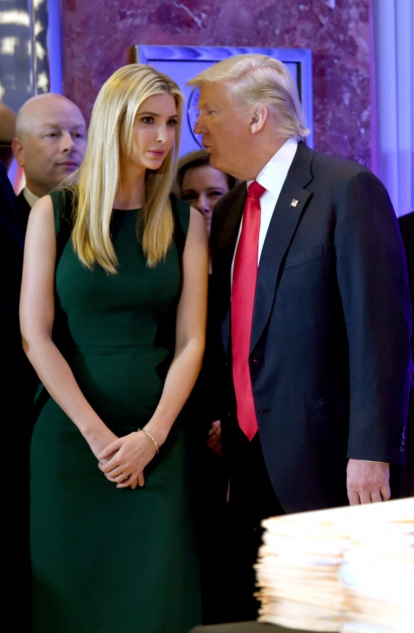 US President-elect Donald Trump whispers to his daughter Ivanka as he arrives for a press conference at Trump Tower in New York on Jan. 11, 2017. (TIMOTHY A. CLARY/AFP/Getty Images)
