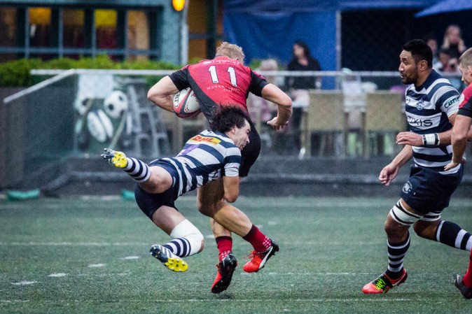 A flying tackle by Natixis HKFC's Marcus Slade on Valley's Max Woodward during their HKRU Premiership match at Sports Road on Saturday Jan 14, 2017. (Dan Marchant)