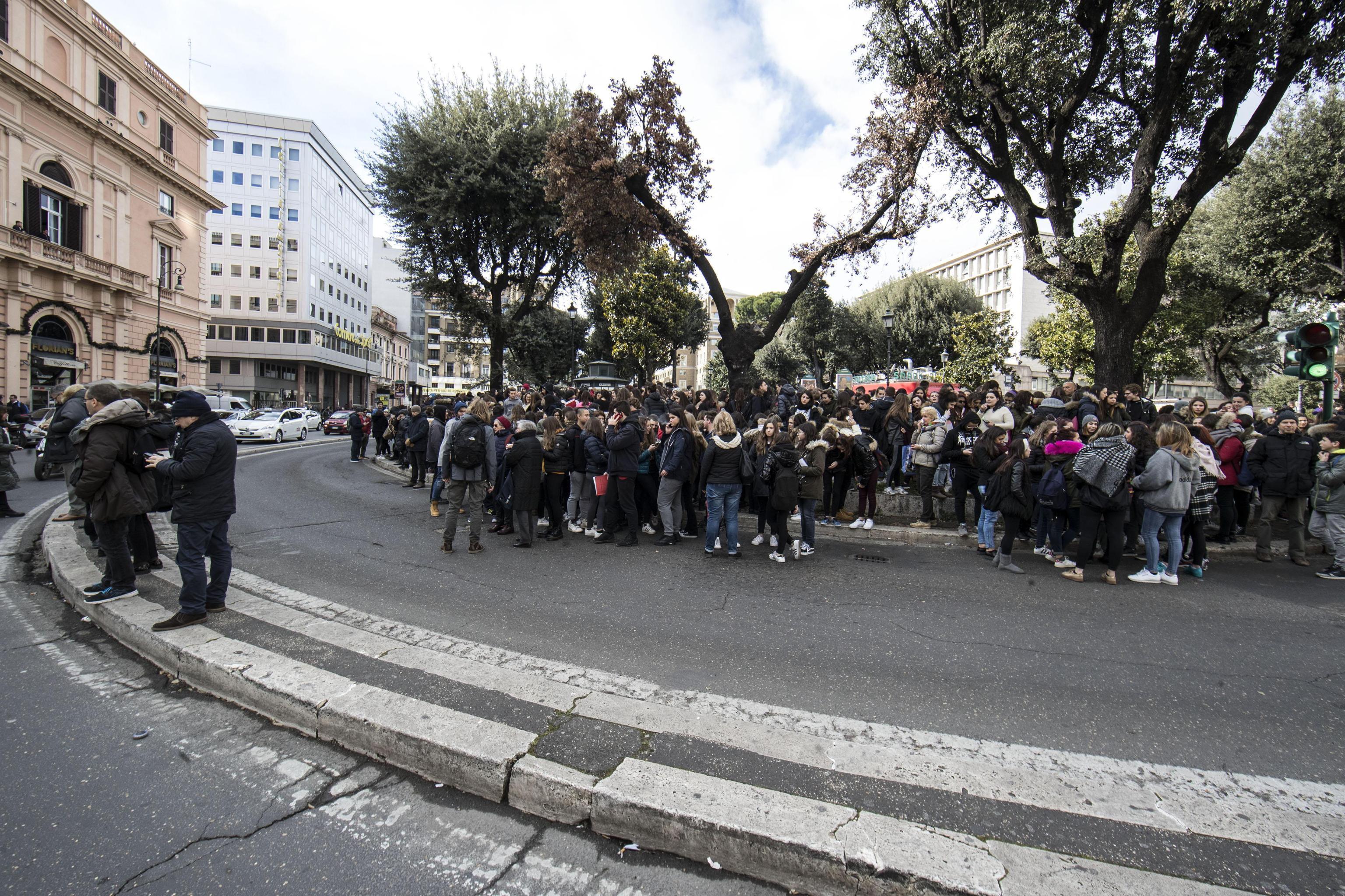 Students and teachers stand outside a highschool after it was evacuated following three earthquakes which hit central Italy in the space of an hour, shaking the same region that suffered a series of deadly quakes last year, in Rome on Jan. 18, 2017. (Massimo Percossi/ANSA via AP)