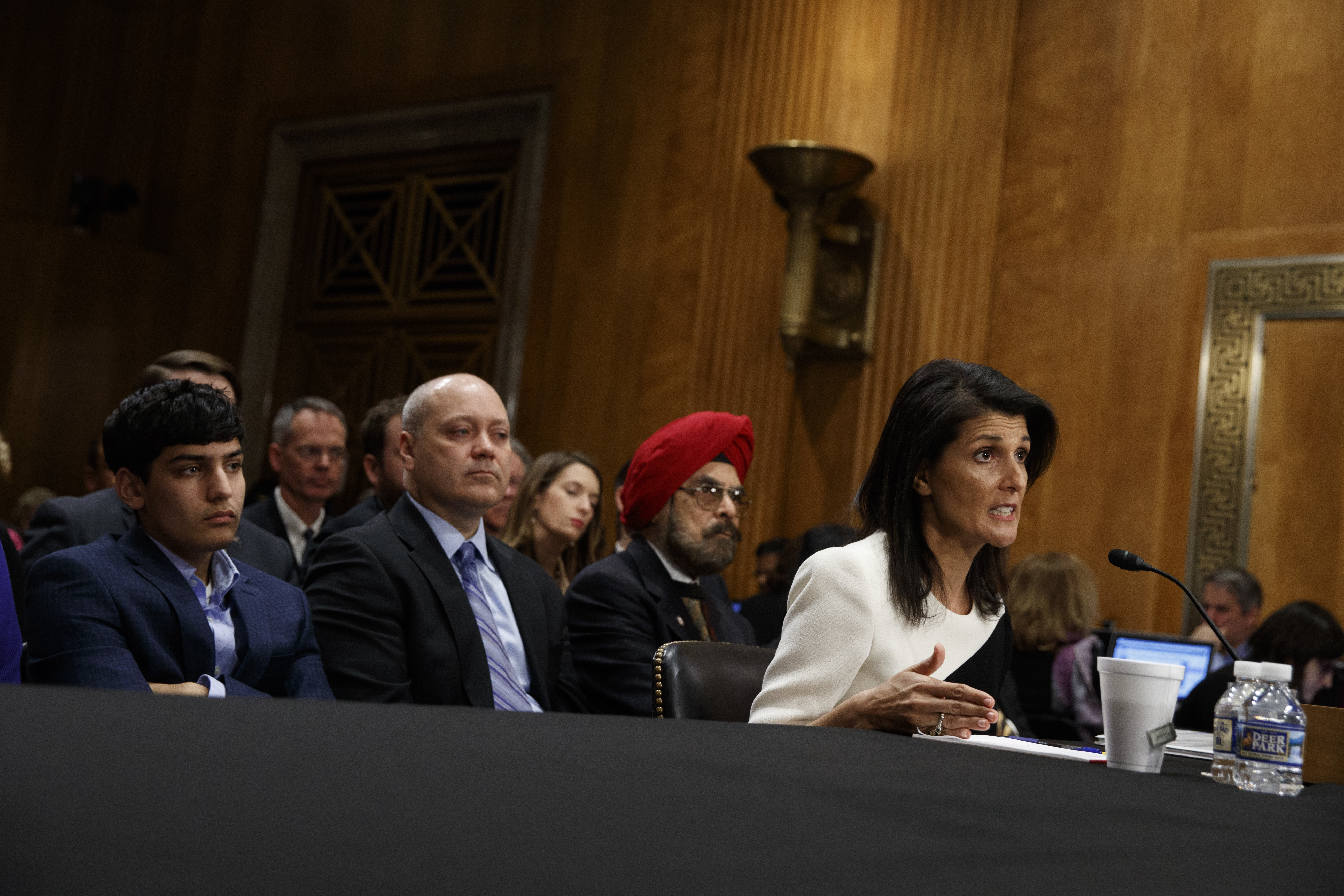 UN Ambassador-designate Gov. Nikki Haley, accompanied by her family (L-R) Nalin Haley, husband Michael Haley and father Dr. Ajit Singh Randhawa, testifies on Capitol Hill in Washington on Jan. 18, 2017. (AP Photo/Evan Vucci)