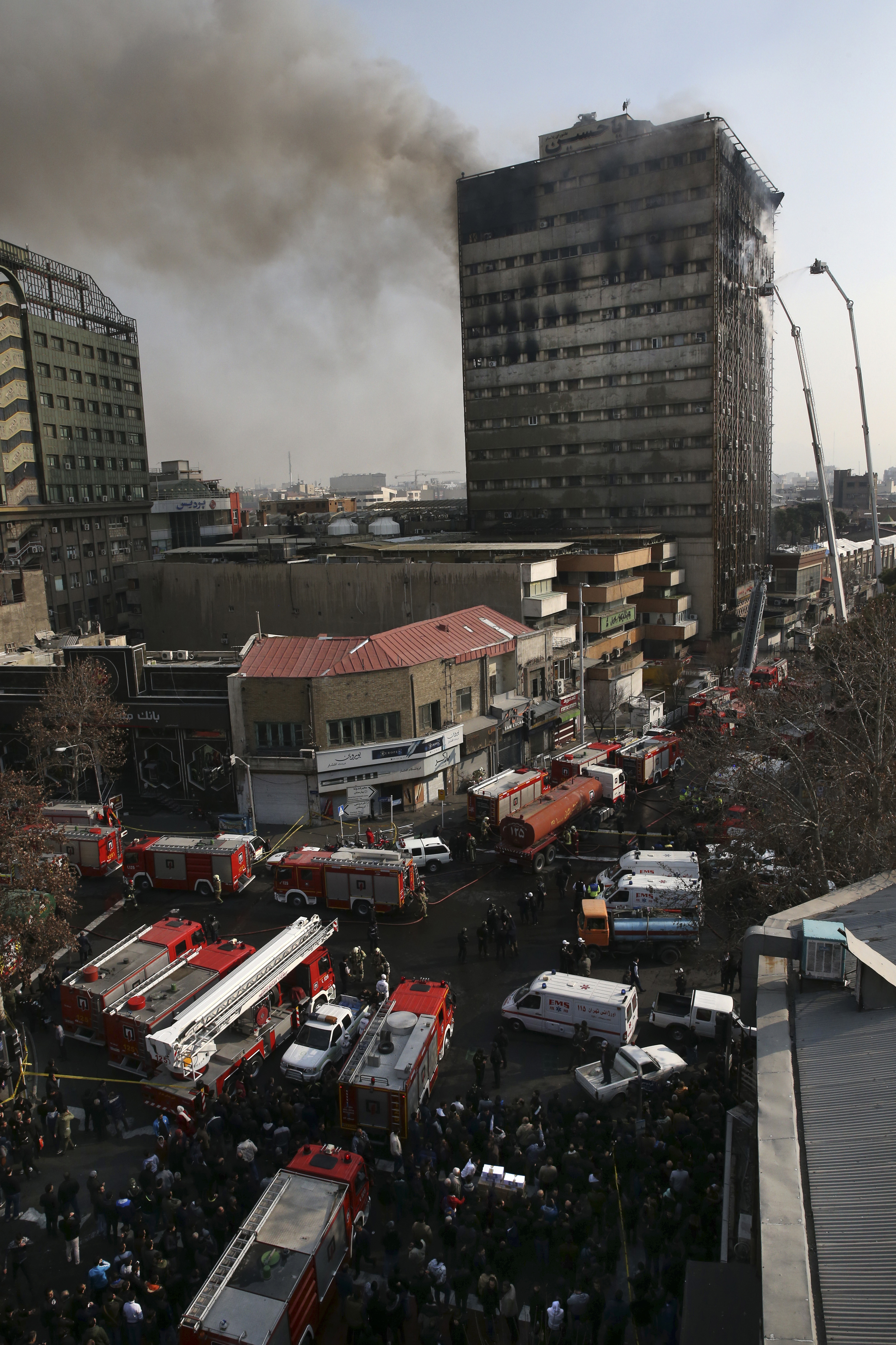 Smoke rises up from the Plasco building where firefighters work to extinguish fire in central Tehran, Iran on Jan. 19, 2017. (AP Photo/Vahid Salemi)