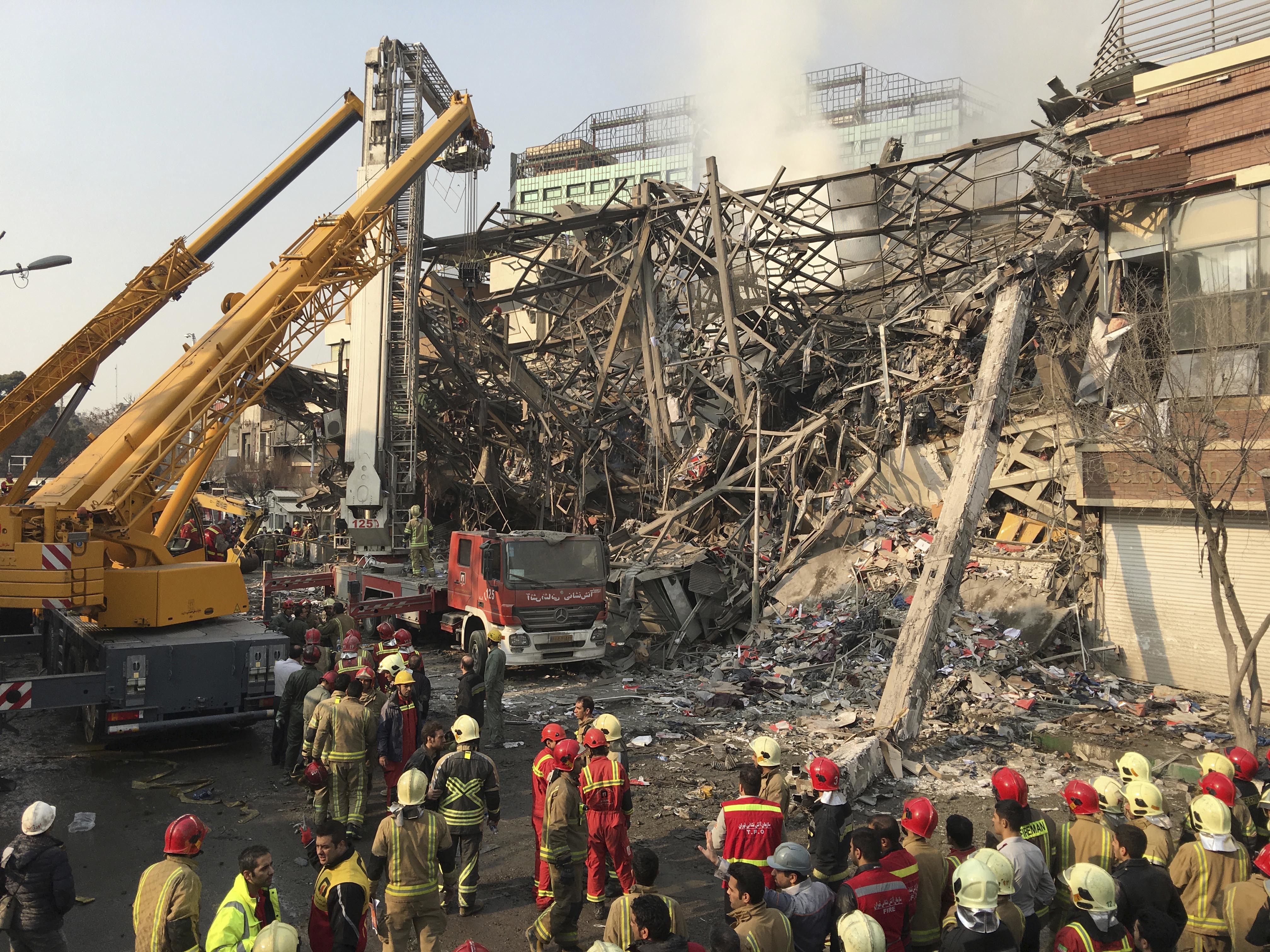 Iranian firefighters work at the scene of the collapsed Plasco building after being engulfed by a fire, in central Tehran, Iran on Jan. 19, 2017. (AP Photo/Ebrahim Noroozi)