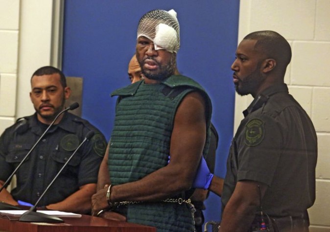 Markeith Loyd, suspected of fatally shooting a Florida police officer, attends his initial court appearance Thursday, Jan. 19, 2017, at the Orange County Jail, in Orlando, Fla. Loyd spoke out of turn and was defiant during the appearance on charges of killing his pregnant ex-girlfriend. He was injured during his arrest Tuesday night following a weeklong manhunt. (Red Huber/Orlando Sentinel via AP, Pool)