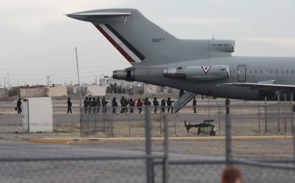 Police board Mexican Air Force plane after the extradition of drug lord Joaquin "El Chapo" Guzman in Ciudad Juarez, Mexico on Jan. 19, 2017. (AP Photo/Christian Torres)