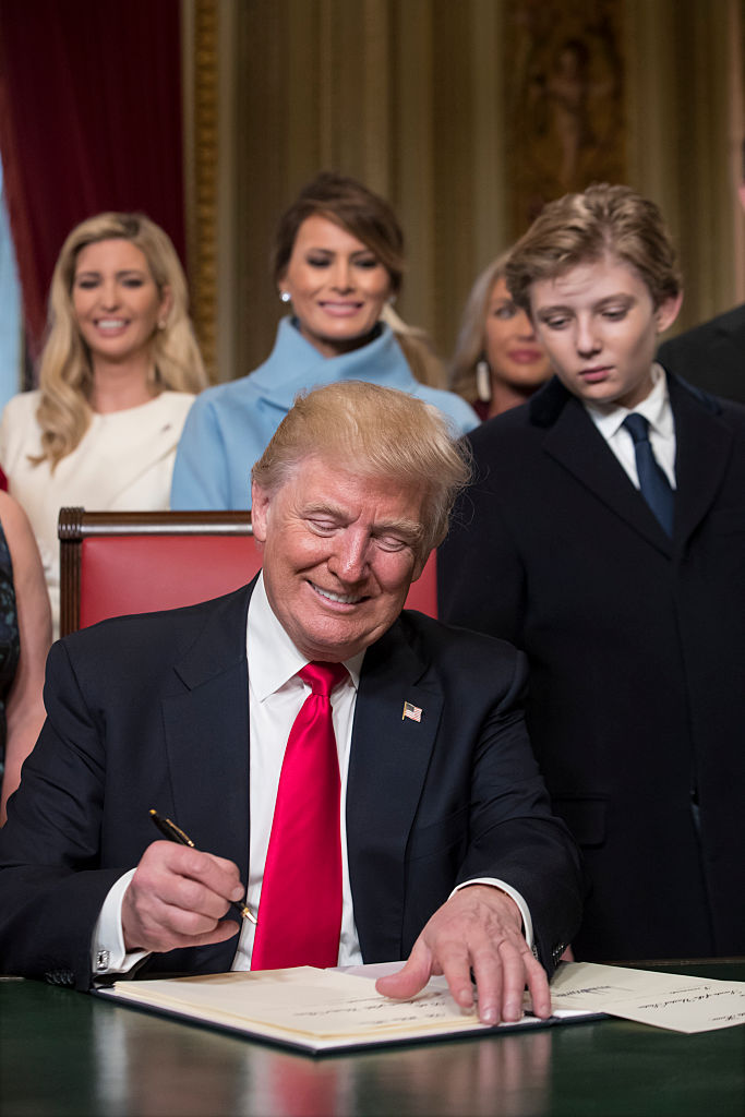 President Donald Trump is joined by the Congressional leadership and his family as he formally signs his cabinet nominations into law, in the President's Room of the Senate, at the Capitol in Washington on Jan. 20, 2017. (Photo by J. Scott Applewhite - Pool/Getty Images)
