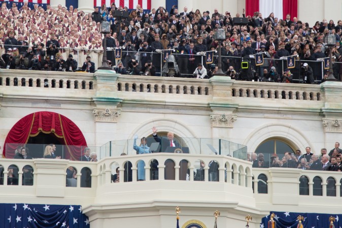President Donald Trump with wife and First Lady, Melania Trump, wave after being sworn in during the 58th Presidential Inauguration at the U.S. Capitol in Washington, on Jan. 20, 2017. (Benjamin Chasteen/Epoch Times)