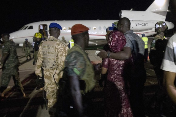 Supporters of Gambia's defeated leader Yahya Jammeh watch as his plane prepares for takeoff as he departs at Banjul airport on Jan. 21, 2017. Jammeh announced early Saturday he has decided to relinquish power, after hours of last-ditch talks with regional leaders and the threat by a regional military force to make him leave. (AP Photo/Jerome Delay)
