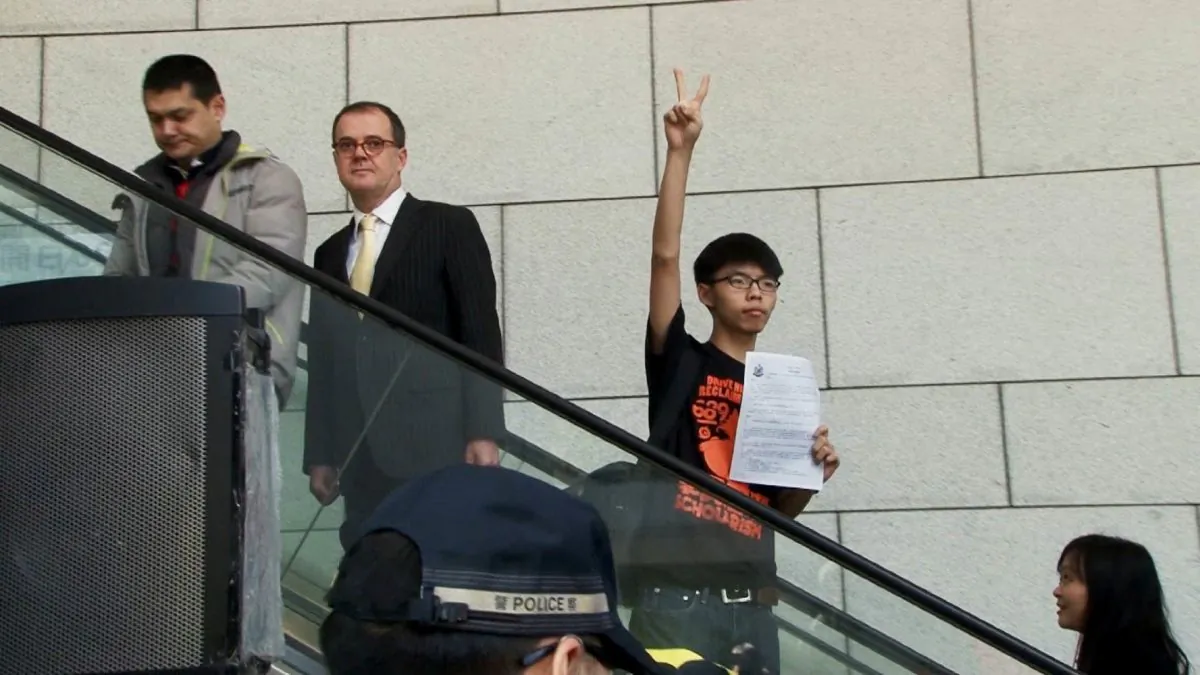 Joshua Wong holding his hand up with the peace sign. (2016 Sundance Institute)