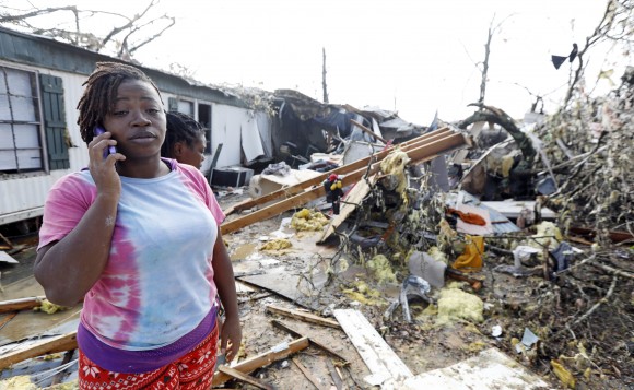 Lanada Miller stands before the remains of her trailer home being ripped apart, while leaving two other trailers with exterior damage in in Hattiesburg, Miss., on Jan. 21, 2017. (AP Photo/Rogelio V. Solis)