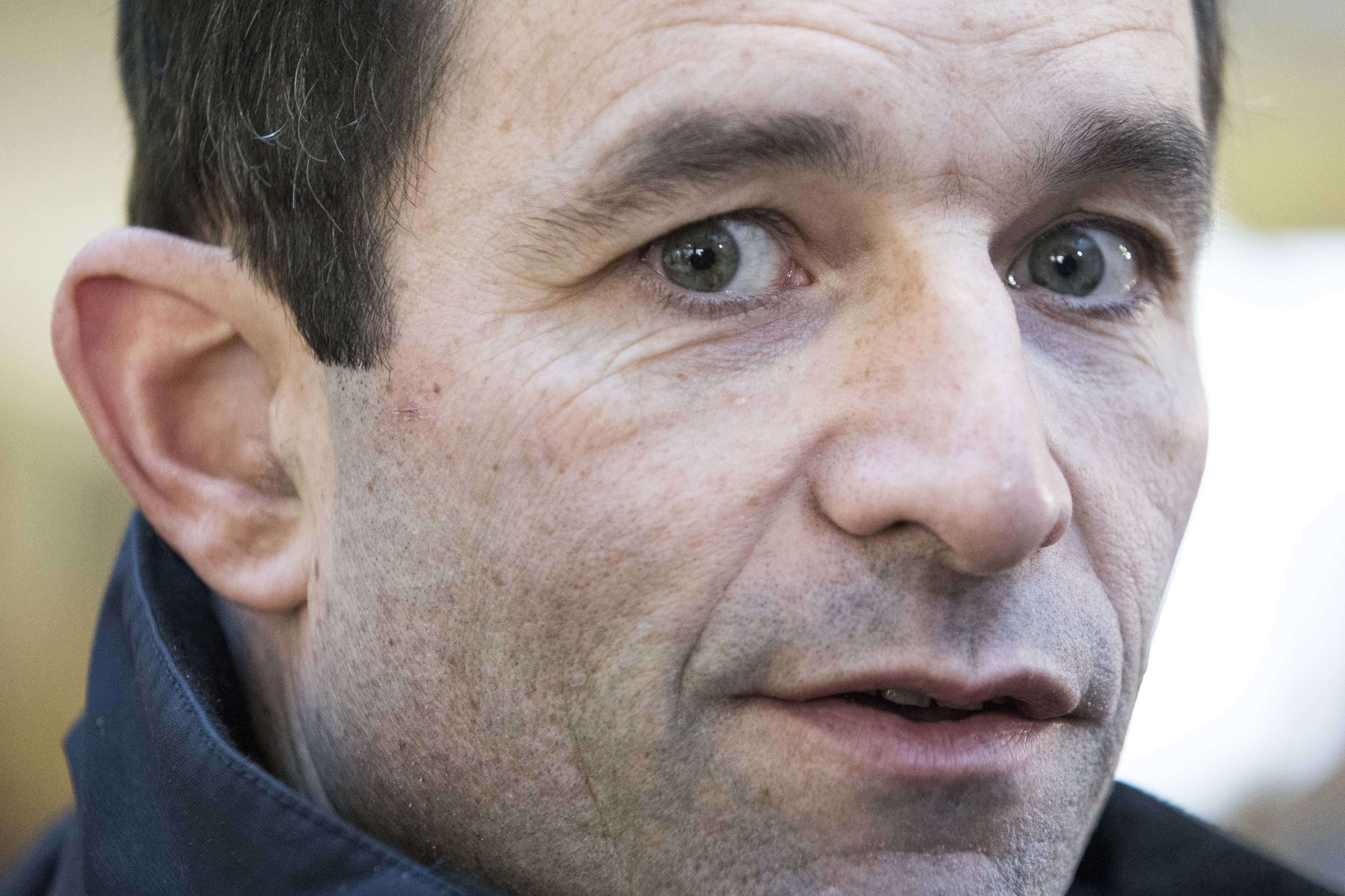 Candidate for the French left's presidential primaries ahead of the 2017 presidential election, Benoit Hamon, speaks to press after the first round of the primaries in Trappes, west of Paris on Jan. 22, 2017. (AP Photo/Kamil Zihnioglu)