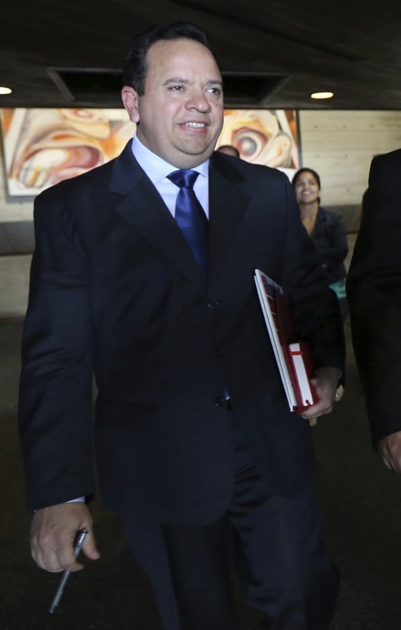 FILE - In this Feb. 10, 2015 file photo, Venezuela's Finance Minister Rodolfo Marco Torres leaves after a press conference at the Central bank in Caracas, Venezuela. Venezuelan officials may face U.S. sanctions for profiting from food shortages that have exacerbated hunger in the South American country. The Associated Press cited documents and testimony from business owners who pointed to food minister Gen. Rodolfo Marco Torres and his predecessor, Gen. Carlos Osorio, as key figures involved in fraudulent food imports. (AP Photo/Ariana Cubillos, File)