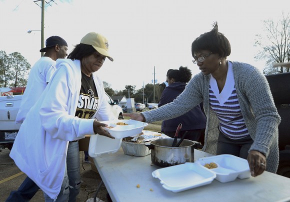 Hattiesburg, Miss., volunteers Brenda Dillion and Vanessa Molden put together boxes of food to give out to tornado victims, law enforcement and others in need of food after Saturday's tornado in Hattiesburg on Sunday, Jan. 22, 2017. The enormous system put millions of people in the South on edge during a weekend of violent weather that left crumpled trailer homes, downed trees and other damage in the hardest-hit communities from Mississippi to Georgia. (Susan Broadbridge/Hattiesburg American via AP)