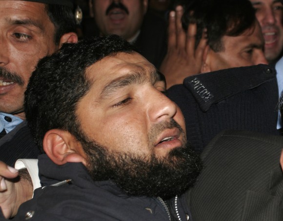 Mumtaz Qadri, who was hanged for killing a Pakistani politician who criticized Pakistan's controversial blasphemy law and defended a Christian woman, arrives at a court in Islamabad, Pakistan in this Jan 5, 2011 file photo. (AP Photo/B.K. Bangash)