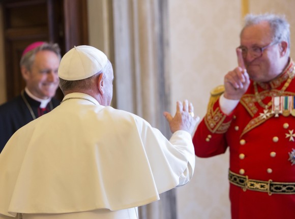 FILE - In this June 25, 2015 file photo, Pope Francis greets the Grand Master of the Sovereign Order of Malta Matthew Festing, right, at the end of a private audience in the Pontiff's private library at the Vatican. Festing resigned after entering into a public spat with Francis over the ouster of a top official involved in a condom scandal, a spokeswoman for the ancient lay Catholic order said on Wednesday, Jan. 25, 2017. (AP Photo/Riccardo De Luca, File)