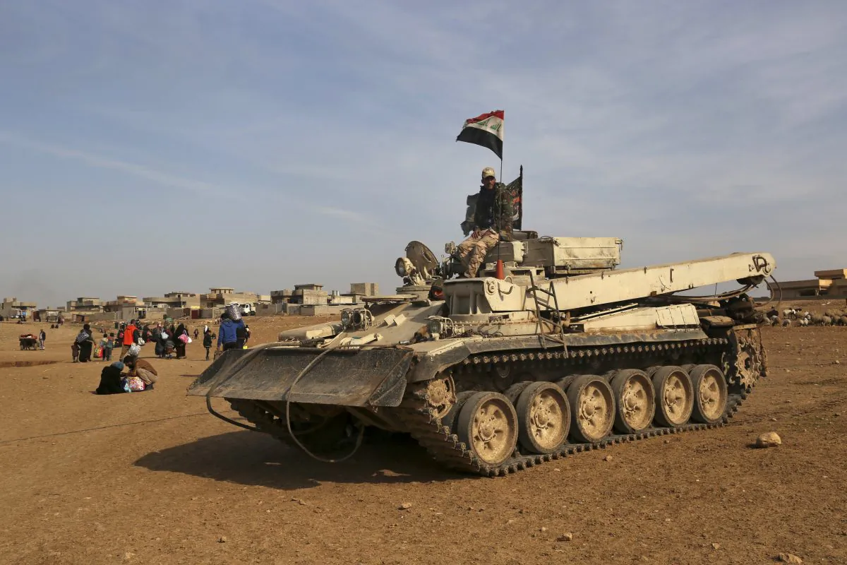 Iraqi Army vehicles advance as civilians flee their villages due to fighting between Iraqi security forces and Islamic State militants, on the outskirts of Mosul, Iraq on Jan. 26, 2017. (AP Photo/Khalid Mohammed)