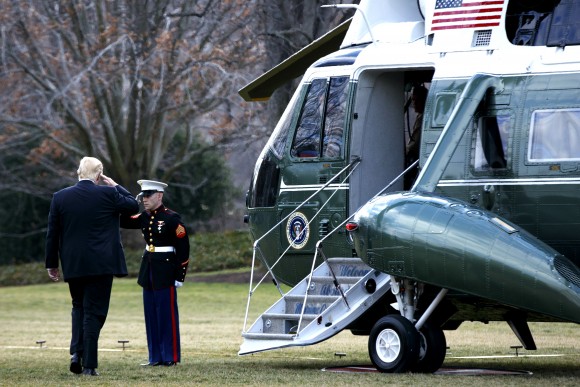 President Donald Trump salutes before boarding Marine One on the South Lawn of the White House in Washington on Jan. 26, 2017. (AP Photo/Evan Vucci)