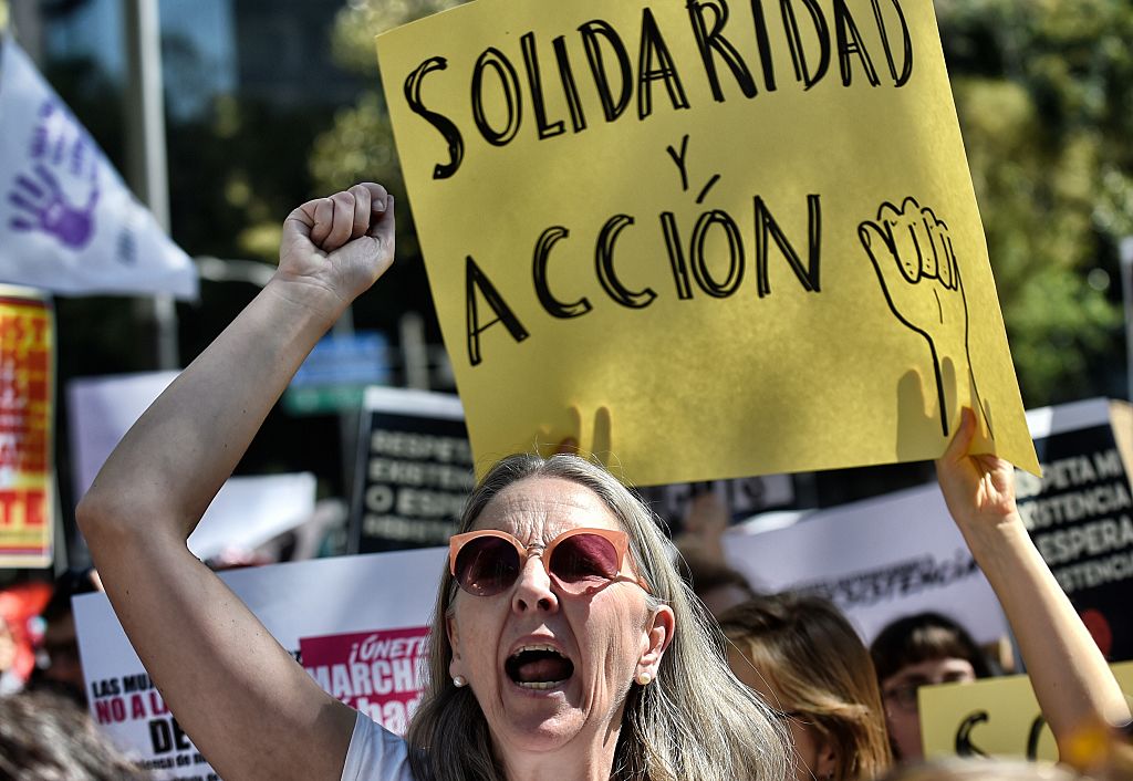 A womna holds a sign reading "Solidarity and action" during the "Women's March" against new US President Donald Trump in Mexico City on Jan.21, 2017. (PEDRO PARDO/AFP/Getty Images)