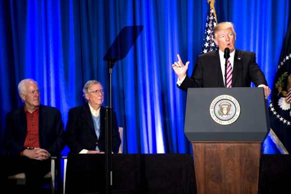President Donald Trump speaks as Sen. John Cornyn (R-TX) (L) and Senate Majority Leader Sen. Mitch McConnell (R-KY) listen during a luncheon at the Congress of Tomorrow Republican Member Retreat in Philadelphia, Pennsylvania on Jan. 26, 2017. (Bill Clark-Pool/Getty Images)