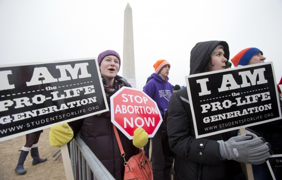 Michelle Doyle, left, joins the March for Life 2016 rally, commemorating the anniversary of 1973 "Roe v. Wade" U.S. Supreme Court decision legalizing abortion in Washington on Jan. 22, 2016. The annual rally will be held Friday on the National Mall in the nation's capital on Jan. 27, 2017. (AP Photo/Manuel Balce Ceneta, File)