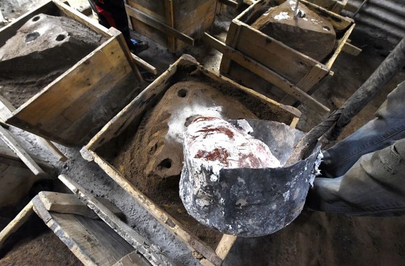 A blacksmith pours aluminium into a mould for making cooking pots on Oct. 12, 2015, in Dakar, Senegal. Pots made from recycled metal in Africa and Asia release lead and other toxins into food, according to a study published in the February 2017 issue of the journal Science of the Total Environment. (Seyllou/Getty Images)