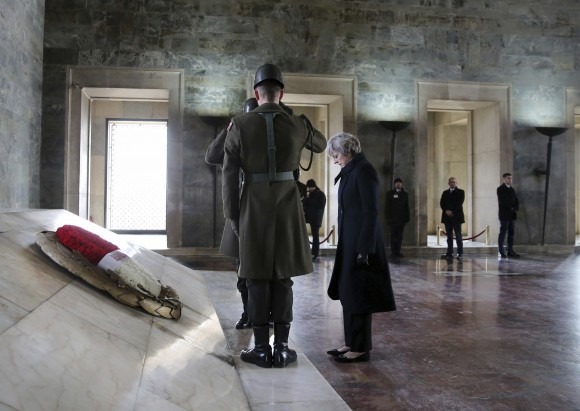 British Prime Minister, Theresa May, stands after laying a wreath at the mausoleum of Turkey's founding father Mustafa Kemal Ataturk, in Ankara, Turkey on Jan. 28, 2017. (Rasit Aydogan/Pool via AP)