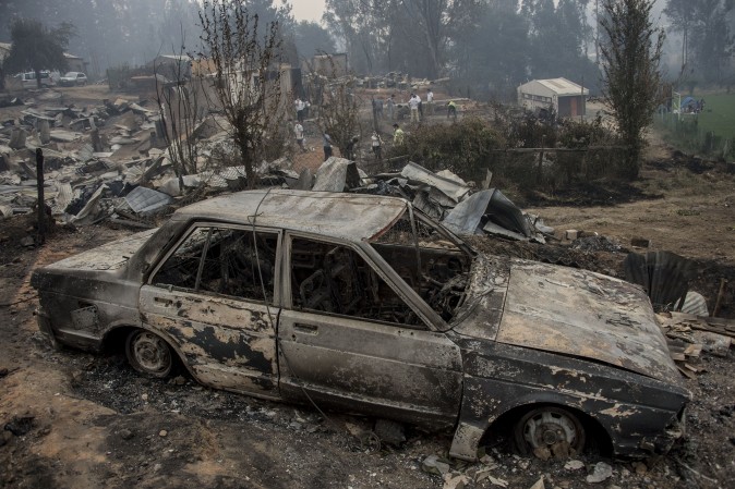 The town of Santa Olga, which was destroyed by a forest fire, 330 km south of Santiago, on Jan. 26. Six people -- among them four firefighters and two police -- have now been killed battling vast forest fires in central Chile, officials said Wednesday. Multiple blazes have ravaged 238,000 hectares (588,000 acres) and are growing, the National Forestry Corporation said in a statement. / AFP / MARTIN BERNETTI (MARTIN BERNETTI/AFP/Getty Images)