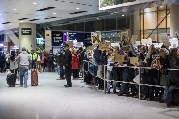 Passengers arrives during a demonstration against the new ban on immigration issued by President Donald Trump at Logan International Airport in Boston, Massachusetts on Jan. 28, 2017. President Trump signed an executive order that halted refugees and residents from predominantly Muslim countries from entering the United States. (Scott Eisen/Getty Images)