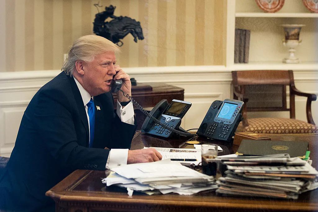 President Donald Trump speaks on the phone with Australian Prime Minister Malcolm Turnbull in the Oval Office of the White House in Washington, DC., on Jan. 28, 2017. (Drew Angerer/Getty Images)