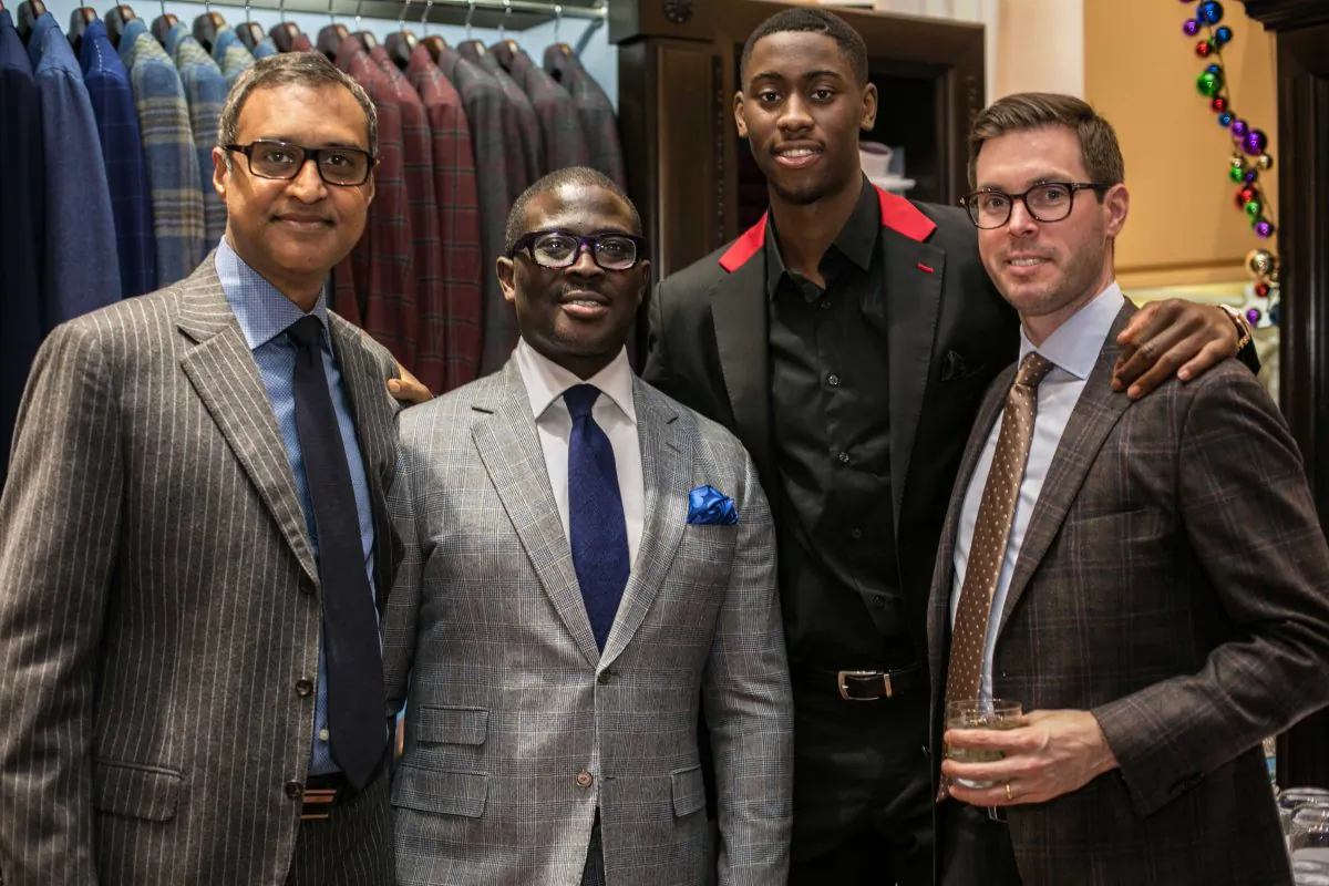 Brand ambassador Brooklyn Net Caris LeVert (C) along with attending guests at the Eredi Pisanò boutique event which is celebrating 15 years on Madison Avenue in New York on Dec. 21, 2016. (Benjamin Chasteen/Epoch Times)