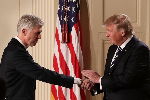 President Donald Trump (R) shakes hands with Judge Neil Gorsuch after nominating him to the Supreme Court during a ceremony in the East Room of the White House in Washington, DC Jan. 31, 2017. If confirmed, Gorsuch would fill the seat left vacant with the death of Associate Justice Antonin Scalia in Feb. 2016. (Chip Somodevilla/Getty Images)