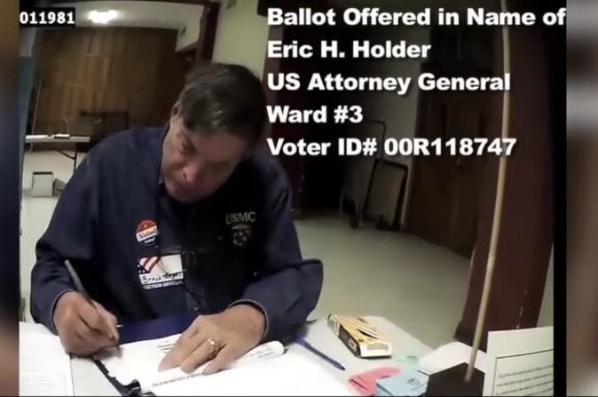 A screenshot by Project Veritas shows a person using an undercover camera walking into a polling station who was approved to vote by using Attorney General Eric Holder's name and address. (Screenshot via Youtube/Project Veritas) 