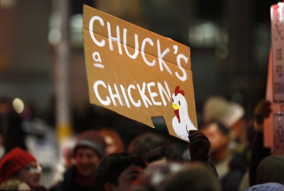 A woman holds a sign referring to the votes of Senate Minority leader Chuck Schumer during the second in a series of "Resist Trump Tuesdays," in New York at Brooklyn's Grand Army Plaza, blocks from the senator's New York city residence on Jan. 31, 2017. Liberals are vowing to put pressure on Schumer to mount a vigorous opposition to the agenda of President Donald Trump. (AP Photo/Kathy Willens)