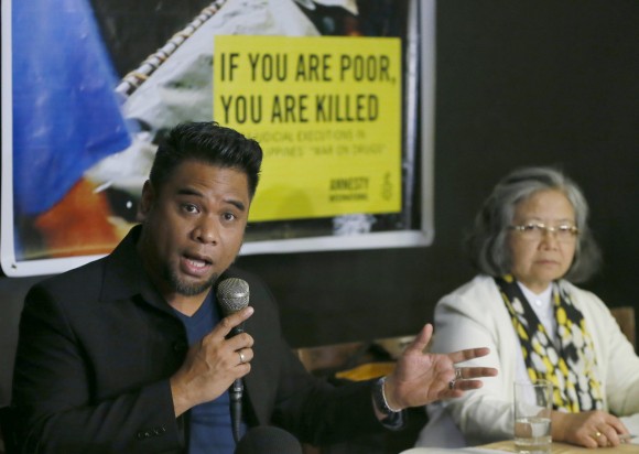 Amnesty International campaigner Wilnor Papa, left, gestures during a video news conference with their London counterpart Rachel Chhoa-Howard and Sis. Maria Vida Cordero, right, in suburban Quezon city, northeast of Manila, Philippines. Wednesday, Feb. 1, 2017. A majority of the thousands of killings of poor suspects under Philippine President Rodrigo Duterte's anti-drug crackdown appear to be "extrajudicial executions," Amnesty International said Wednesday, and may constitute crimes against humanity. (AP Photo/Bullit Marquez)