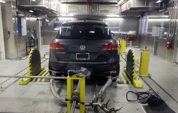 FILE - In this Oct. 13, 2015, file photo, a Volkswagen Touareg diesel is tested in the Environmental Protection Agency's cold temperature test facility in Ann Arbor, Mich. Volkswagen has agreed to pay at least US$ 1.2 billion in buybacks and compensation to settle claims from U.S. owners of cars with larger diesel engines that the company rigged to cheat on emissions tests. The proposed settlement filed late Tuesday, Jan. 31, 2017 in U.S. District Court in San Francisco covers owners of some 75,000 Audi, Volkswagen and Porsche cars with 3.0-liter diesel engines. (AP Photo/Carlos Osorio, File)