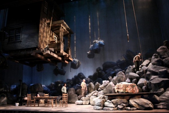 Using startling imagery of huge boulders and a whole house hoisted above the characters, Walt Spangler's set for "Desire Under the Elms" portends the doom resulting from heavy sins. (Courtesy of Walt Spangler)