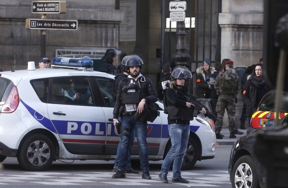 Police officers guard the access to the Louvre museum in Paris,Friday, Feb. 3, 2017. Paris police say a soldier has opened fire outside the Louvre Museum after he was attacked by someone, and the area is being evacuated. (AP Photo/Thibault Camus)