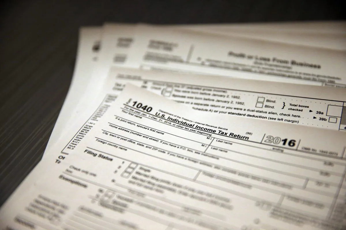 Tax forms sit on a desk at the start of the tax season rush, inside the offices of tax preparation firm Infinite Tax Solutions, in Boulder, Colo. (AP Photo/Brennan Linsley)