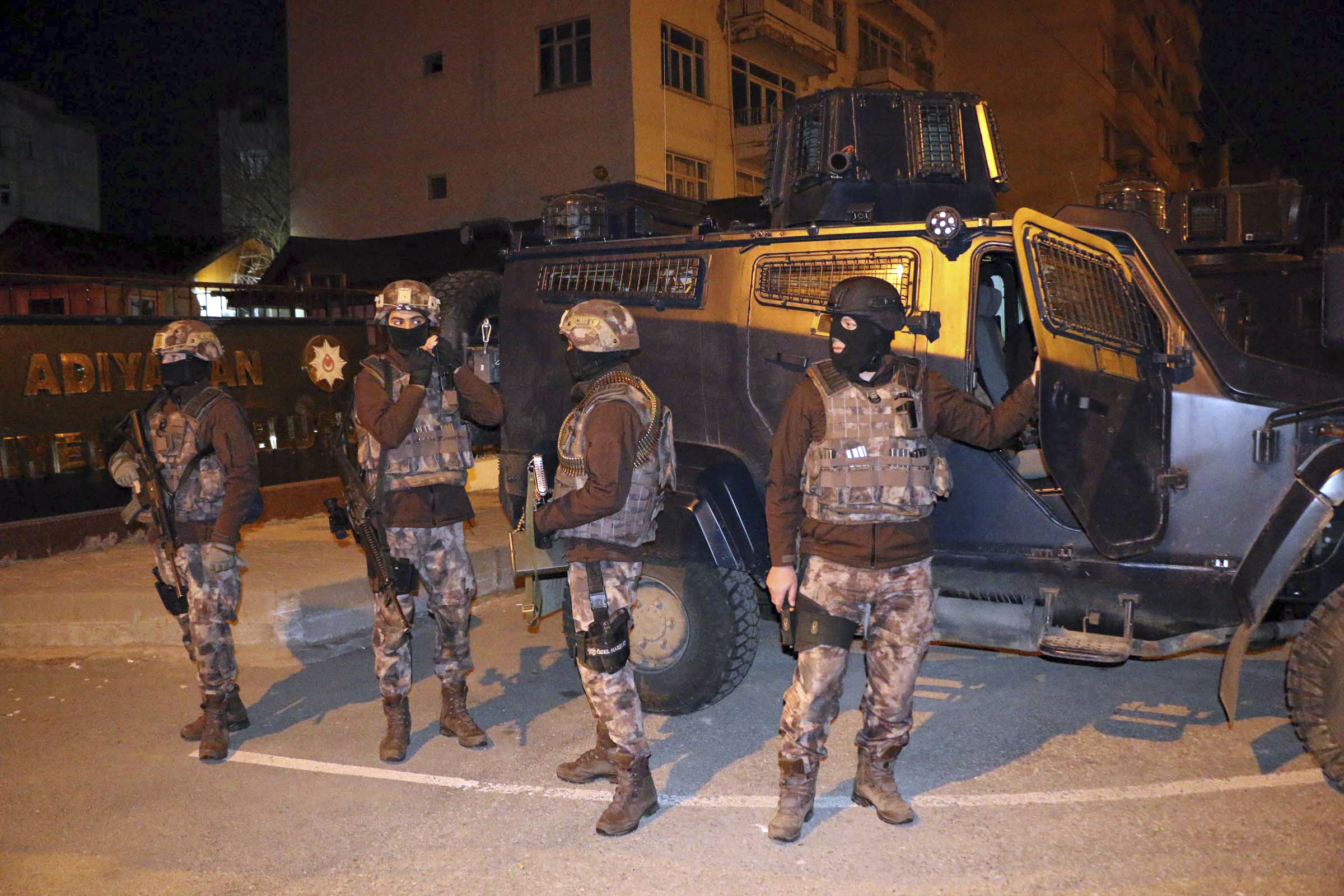 Turkish anti-terrorism police stand by their armoured vehicle during an operation to arrest people over alleged links to ISIS, in Adiyaman, southeastern Turkey on Feb. 5, 2017. (Mahir Alan/Dha-Depo Photos via AP)