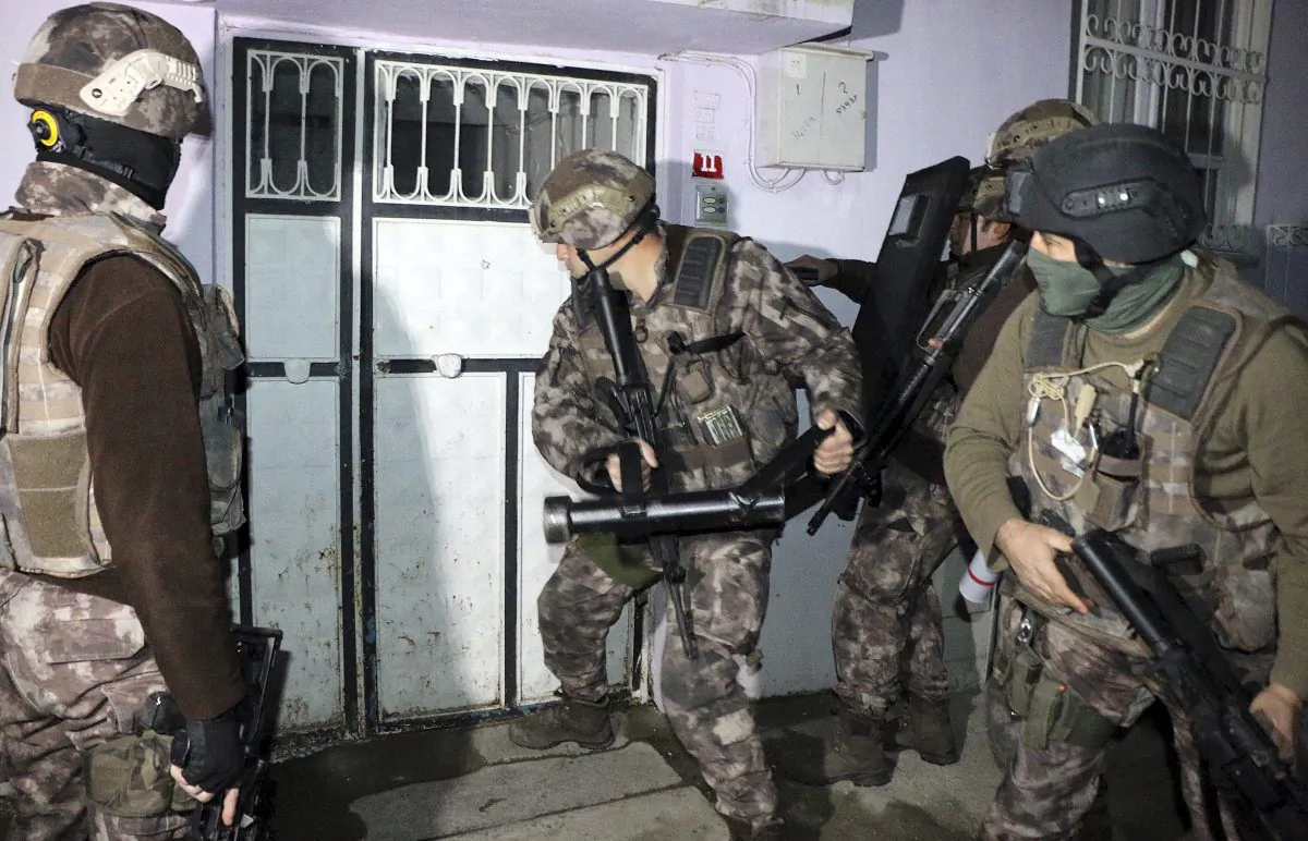 Turkish anti-terrorism police break a door during an operation to arrest people over alleged links to ISIS, in Adiyaman, southeastern Turkey on Feb. 5, 2017. (Mahir Alan/Dha-Depo Photos via AP)