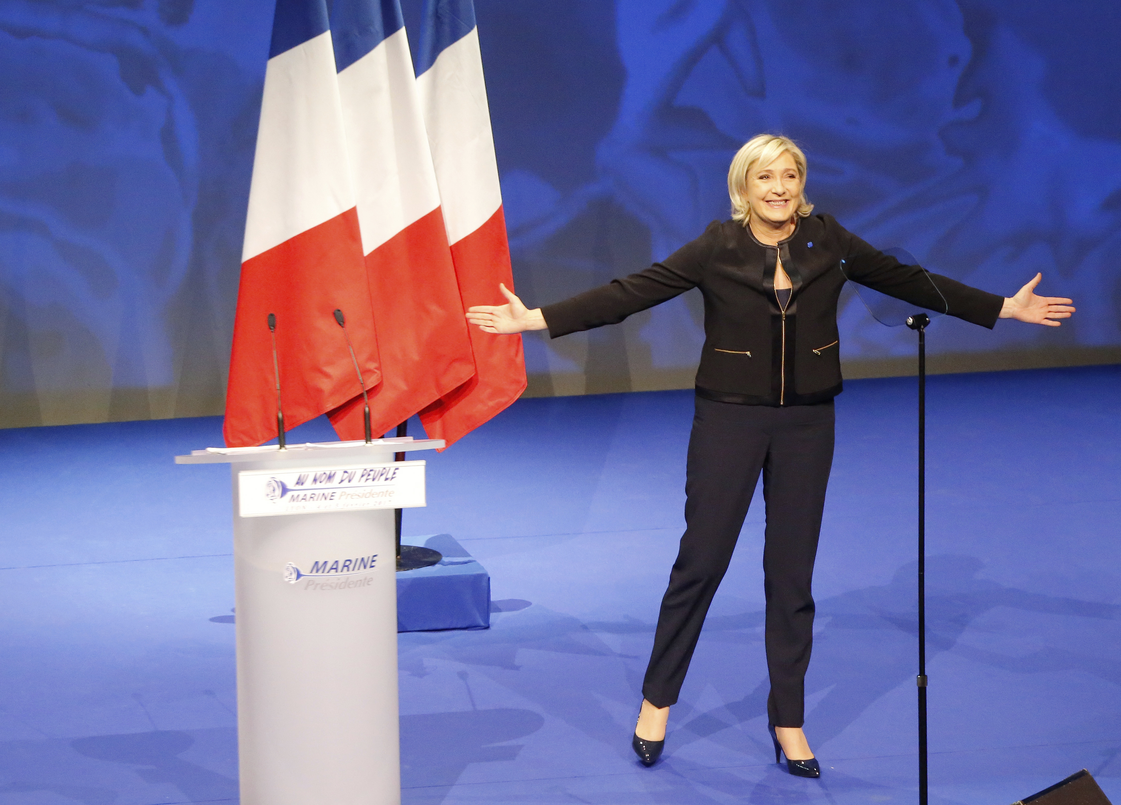 Conservative leader presidential candidate Marine Le Pen acknowledges applauses as she arrives as to a conference in Lyon, France on Feb. 5, 2017. (AP Photo/Michel Euler)