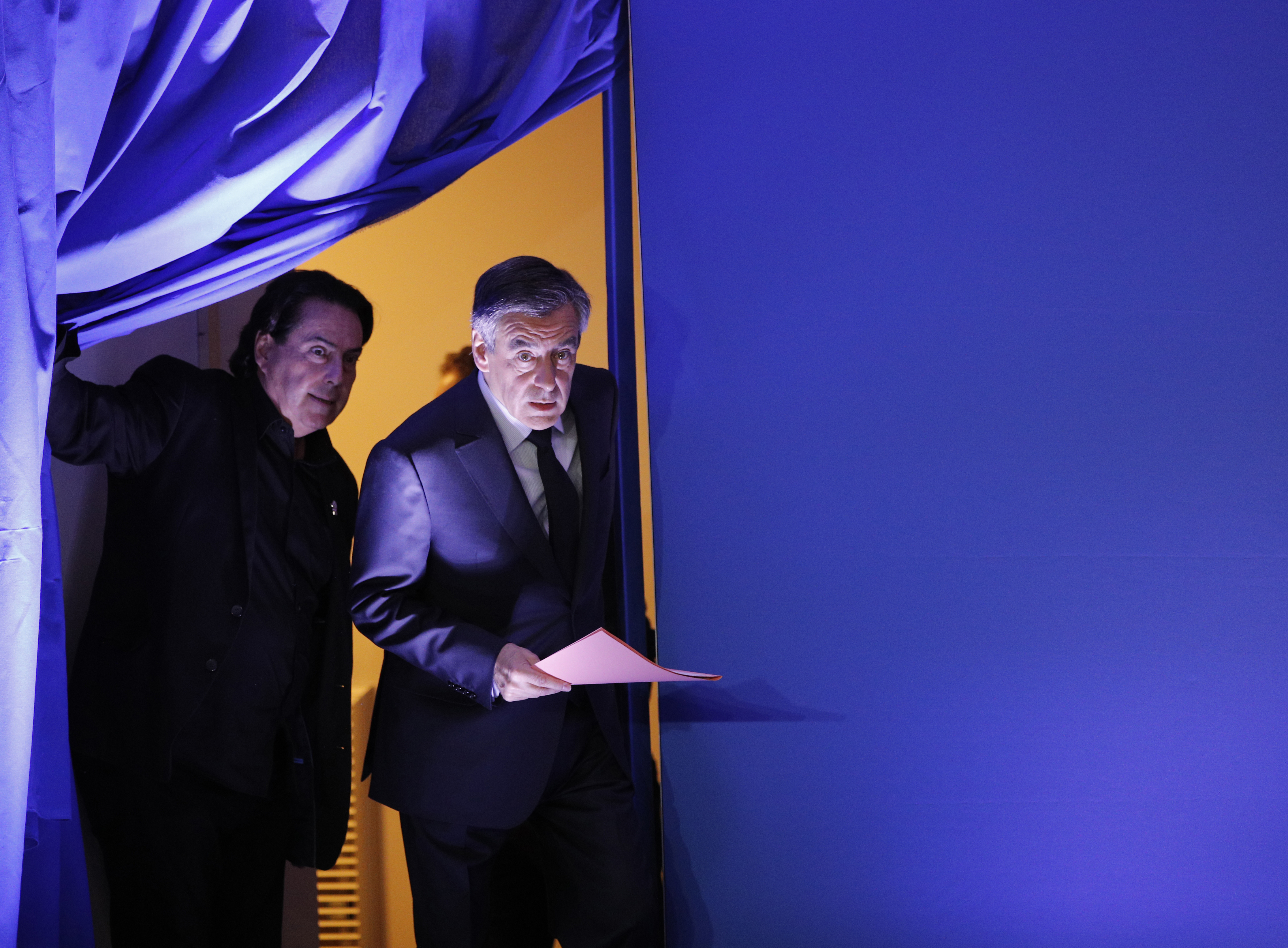 French conservative Francois Fillon (R) arrives on stage to hold a press conference at his campaign headquarters in Paris, France on Feb. 6, 2017. (AP Photo/Christophe Ena)