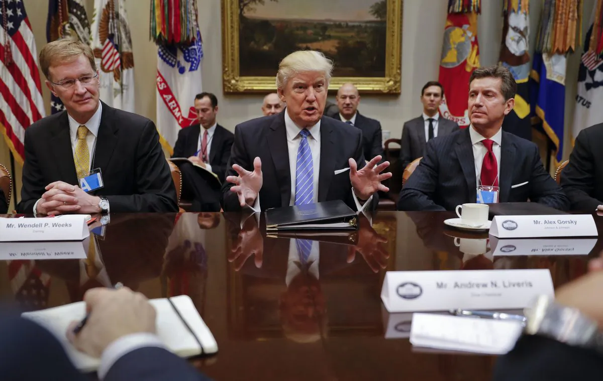 President Donald Trump speaks while hosting a breakfast with business leaders in the Roosevelt Room of the White House in Washington,  Jan. 23, 2017. At left is Wendell P. Weeks, Chief Executive Officer of Corning, at right is Alex Gorsky Chairman and Chief Executive Officer of Johnson & Johnson. (AP Photo/Pablo Martinez Monsivais)