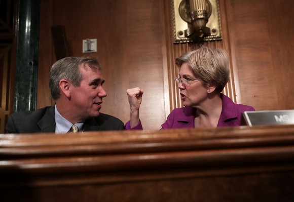 Sen. Jeff Merkley (D-OR) (L) talks to Sen. Elizabeth Warren (D-MA) (R) prior to a hearing before the Senate Banking, Housing and Urban Affairs Committee April 7, 2016 on Capitol Hill in Washington, DC. (Alex Wong/Getty Images)