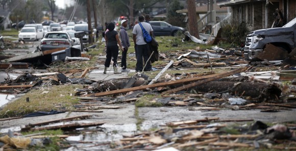 People walk amongst debris from destroyed homes after a tornado tore through the eastern neighborhood in New Orleans, Tuesday, Feb. 7, 2017. Gov. John Bel Edwards has declared a state of emergency for Louisiana after a severe storm moved across the state's southeast corner, including the parishes of Ascension, Livingston, Orleans, St. James, St. Tammany and Tangipahoa. (AP Photo/Gerald Herbert)