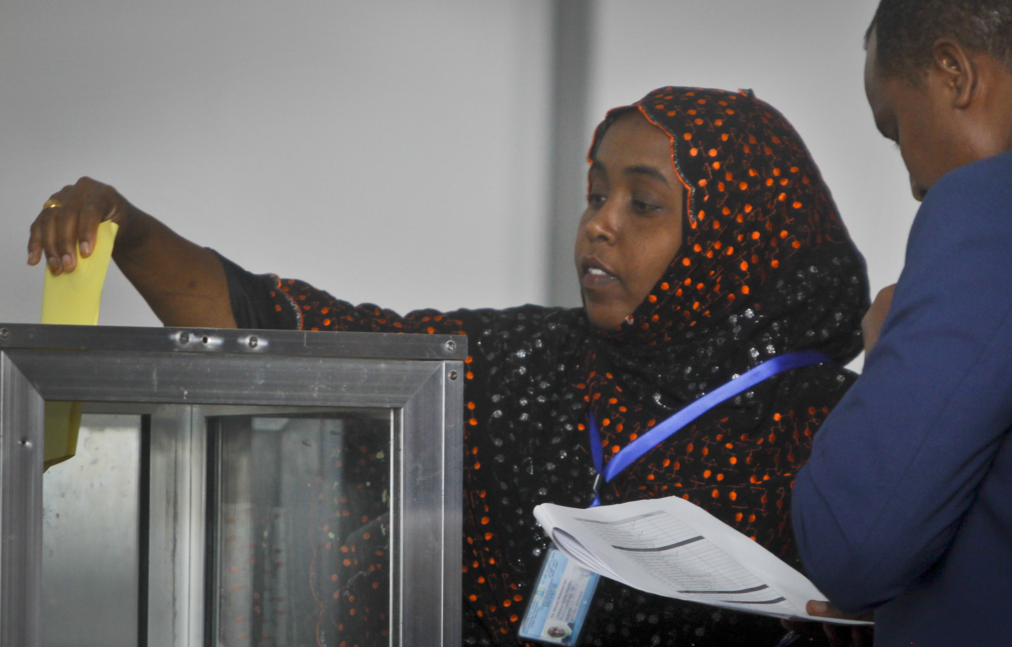 An unidentified Somali member of parliament casts her vote for the presidential election in Mogadishu, Somalia Wednesday, Feb. 8, 2017. Voting started Wednesday in Somalia's groundbreaking presidential election as members of the upper and lower houses of the legislature cast ballots in the first round with 21 candidates for president, amid a security lockdown that has closed the capital's international airport and cleared major streets. (AP Photo/Farah Abdi Warsameh)