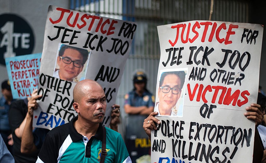 Activists hold a protest in front of Camp Crame, the headquarters of the Philippine National Police (PNP), carrying mock dead bodies, condemning the government's War on Drugs and holding placards showing the picture of the late South Korean businessman Jee Ick-Joo, who was murdered allegedly by suspected policemen in Manila on January 27, 2017. (NOEL CELIS/AFP/Getty Images)