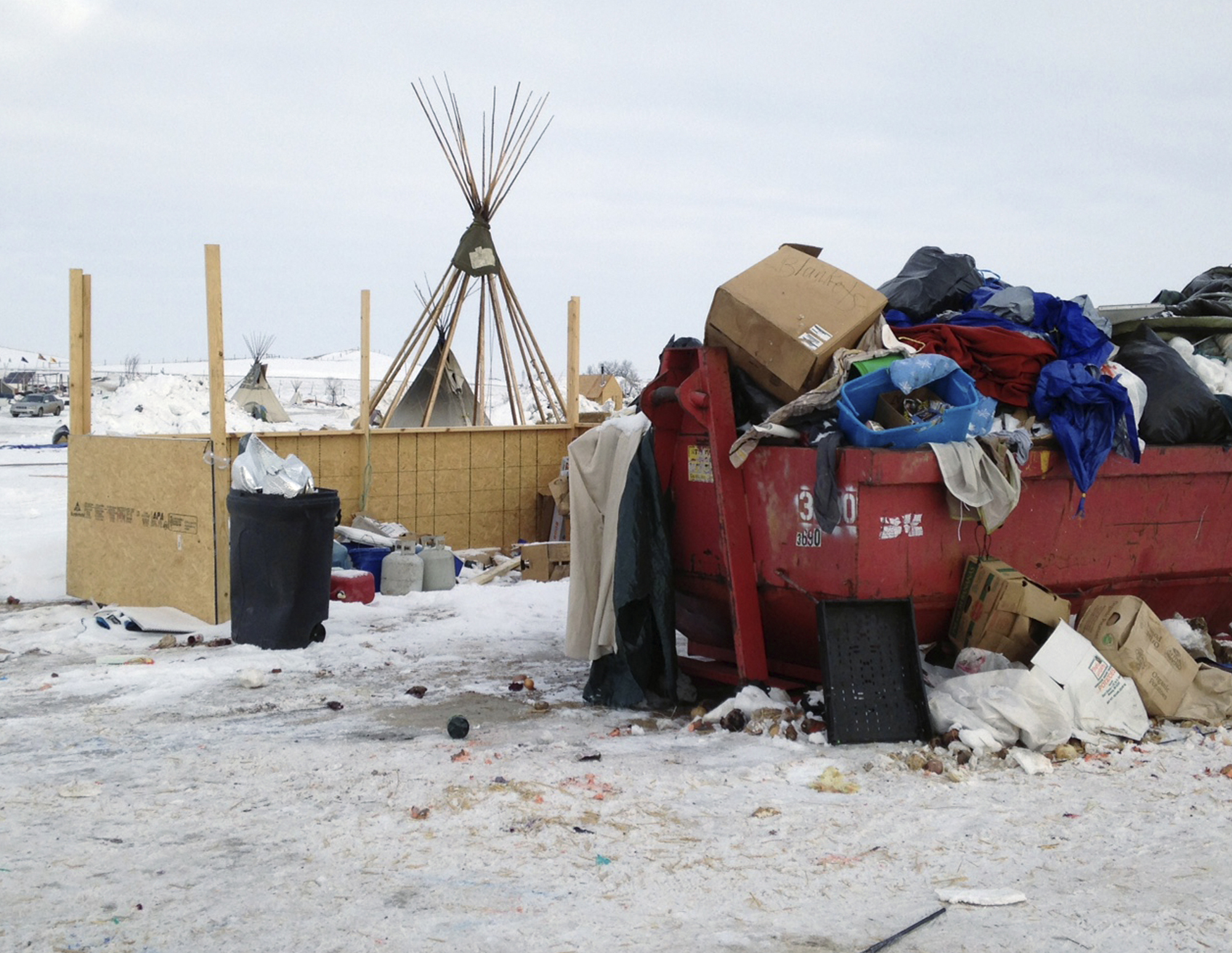 Trash is seen piled in a dumpster at an encampment set up near Cannon Ball, N.D., on Feb. 8, 2017, for opponents against the construction of the Dakota Access pipeline. (AP Photo/James MacPherson)