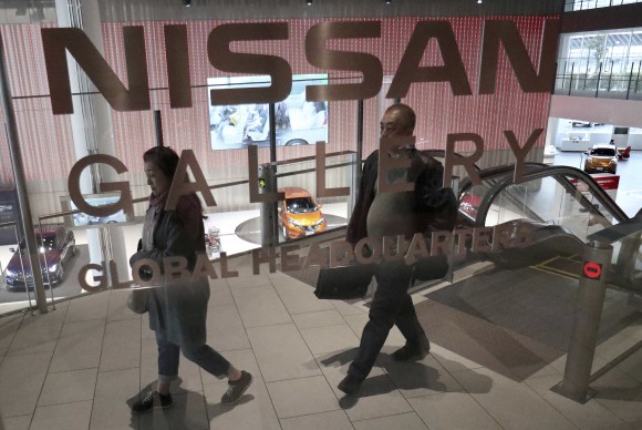 Visitors walk around a gallery of the Nissan Motor Co. at its global headquarters in Yokohama, near Tokyo, on Feb. 9, 2017. (AP Photo/Shizuo Kambayashi)