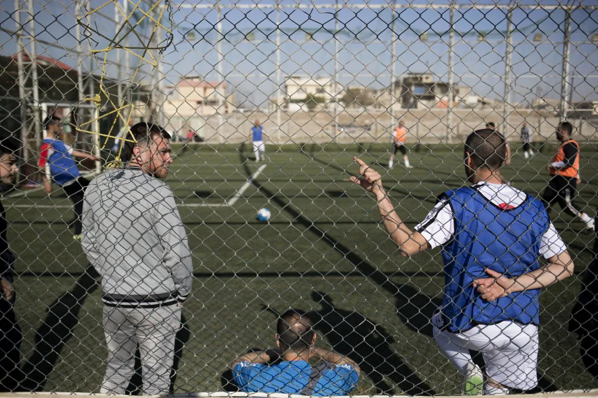 Mosul residents play soccer on a pitch in the liberated eastern part of the city on Feb. 8, 2017. (AP Photo/Bram Janssen)